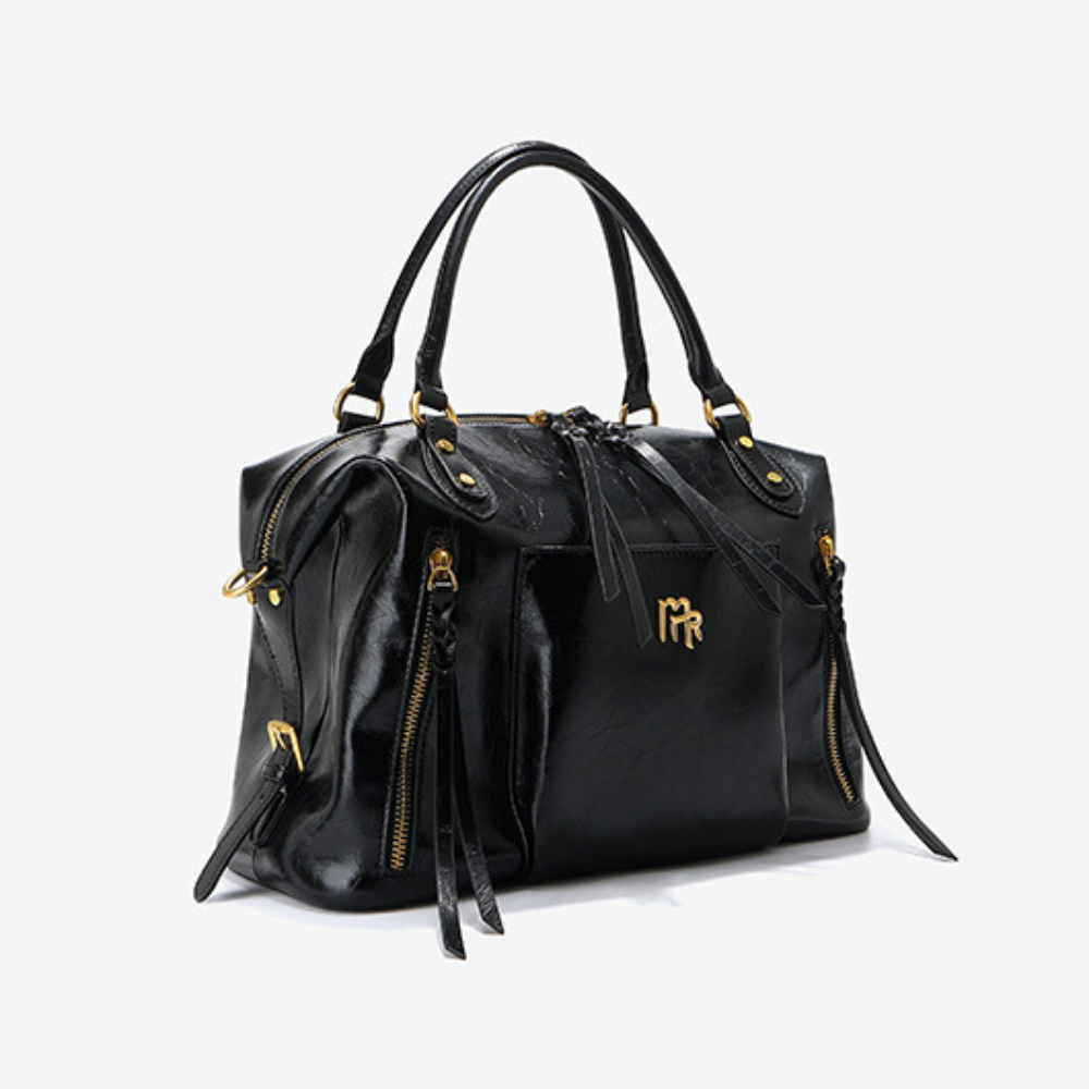 Sac à main femme en cuir noir Élégance Cuir, élégant et sophistiqué, avec poignées et fermeture métallique visible.