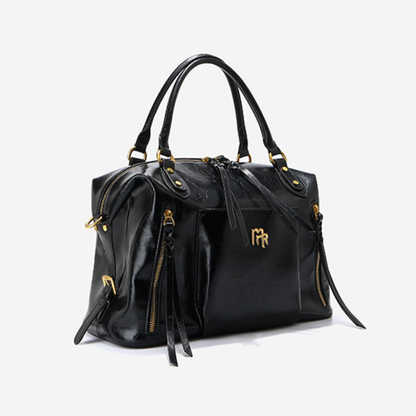 Sac à main femme en cuir noir Élégance Cuir, élégant et sophistiqué, avec poignées et fermeture métallique visible.