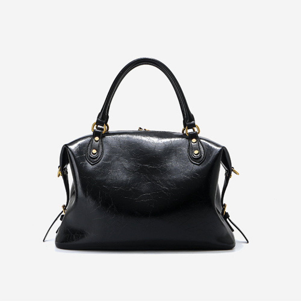 Sac à main femme en cuir noir Élégance Cuir, élégant sac à main en cuir avec poignées et fermeture métallique visible.