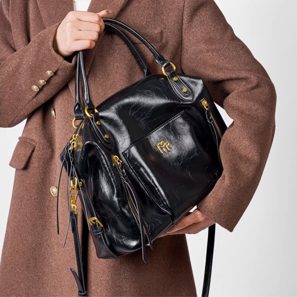 Sac à main pour femme en cuir noir Élégance Cuir, avec poches et poignées élégantes, vue de face.