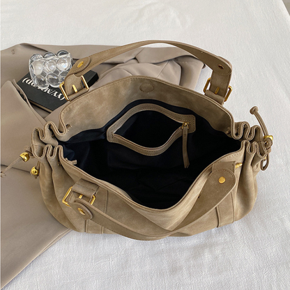 Grand sac à main de cours bowling Élégance Cuir Noemi 2, en cuir marron avec poignées et fermeture métallique élégante.