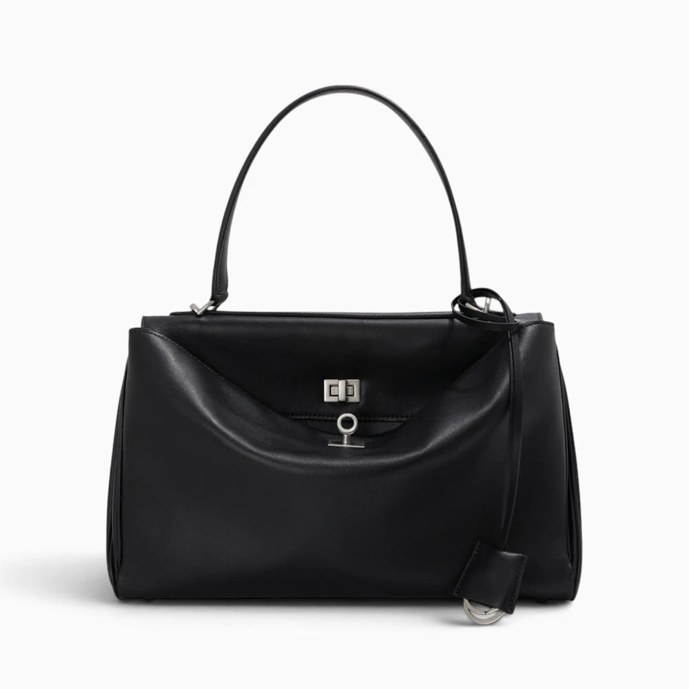 Sac à main cabas pour femme en cuir de la marque Élégance Cuir, avec poignées et design élégant, sur fond neutre.