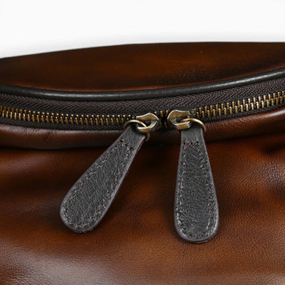 Sac à dos en cuir rond pour femme avec rabat zippé, modèle Nostalgie de la marque Élégance Cuir.