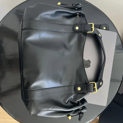 Sac à main vintage Noemi en cuir noir, élégant et sophistiqué, avec poignées en cuir et détail vintage visible.