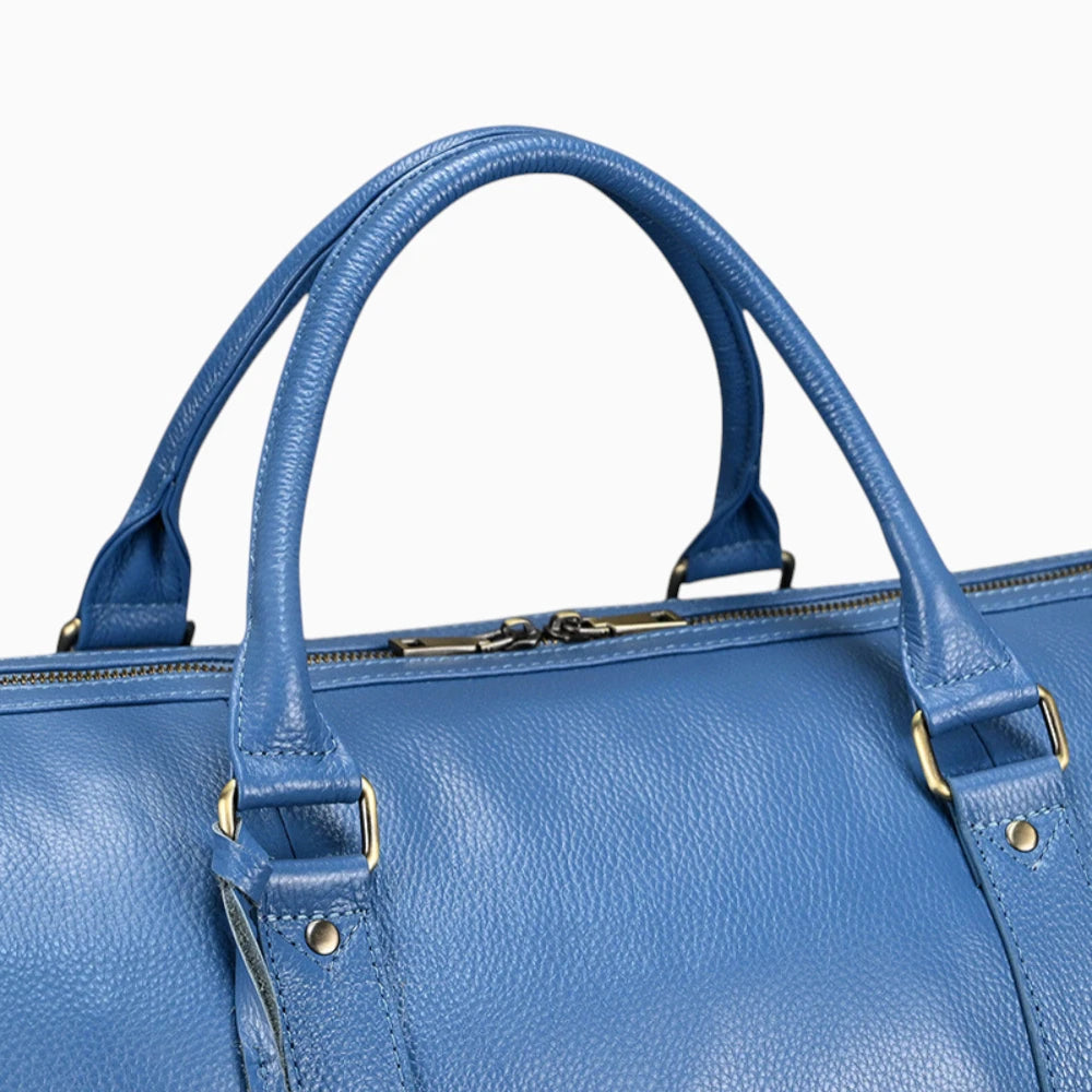 Détail des poignées du sac de voyage en cuir bleu