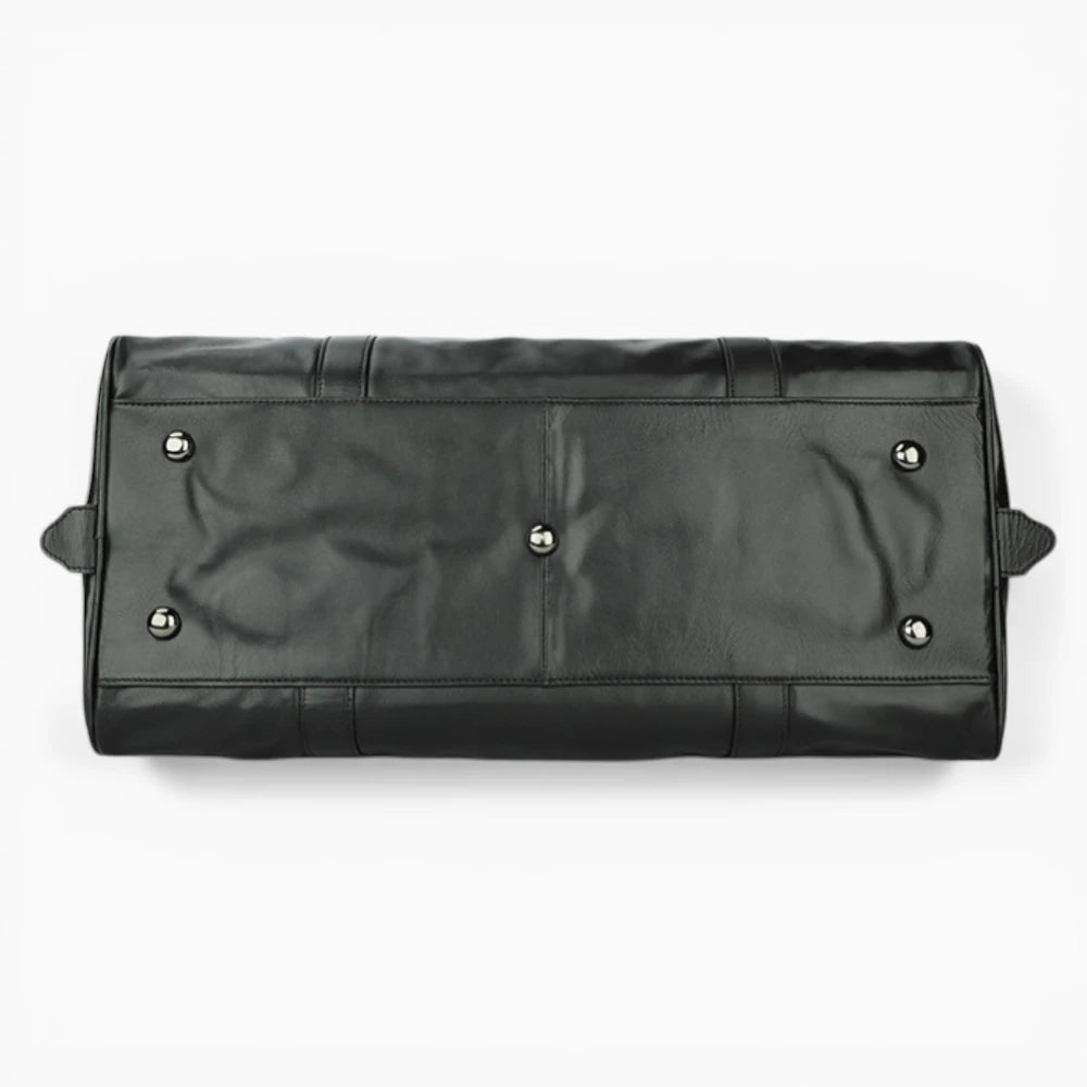 Dessous du sac de voyage en cuir noir avec pieds de protection